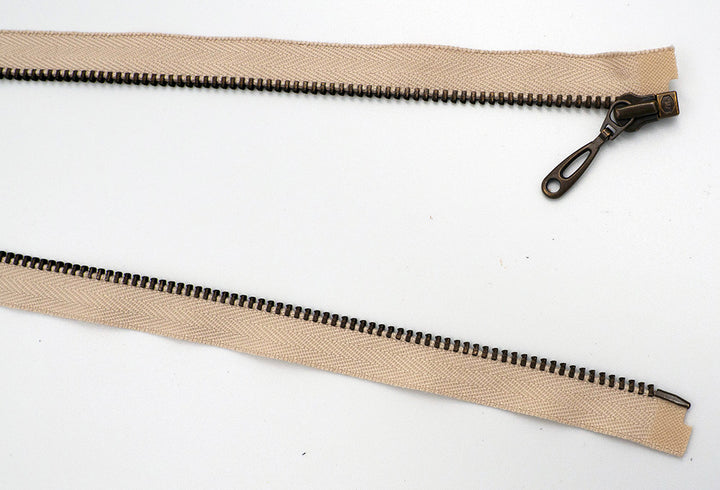 Coil Zipper: Open End / Metal Teeth / Teardrop Pull / Tape Colour is Tan / Teeth Colour is Brass